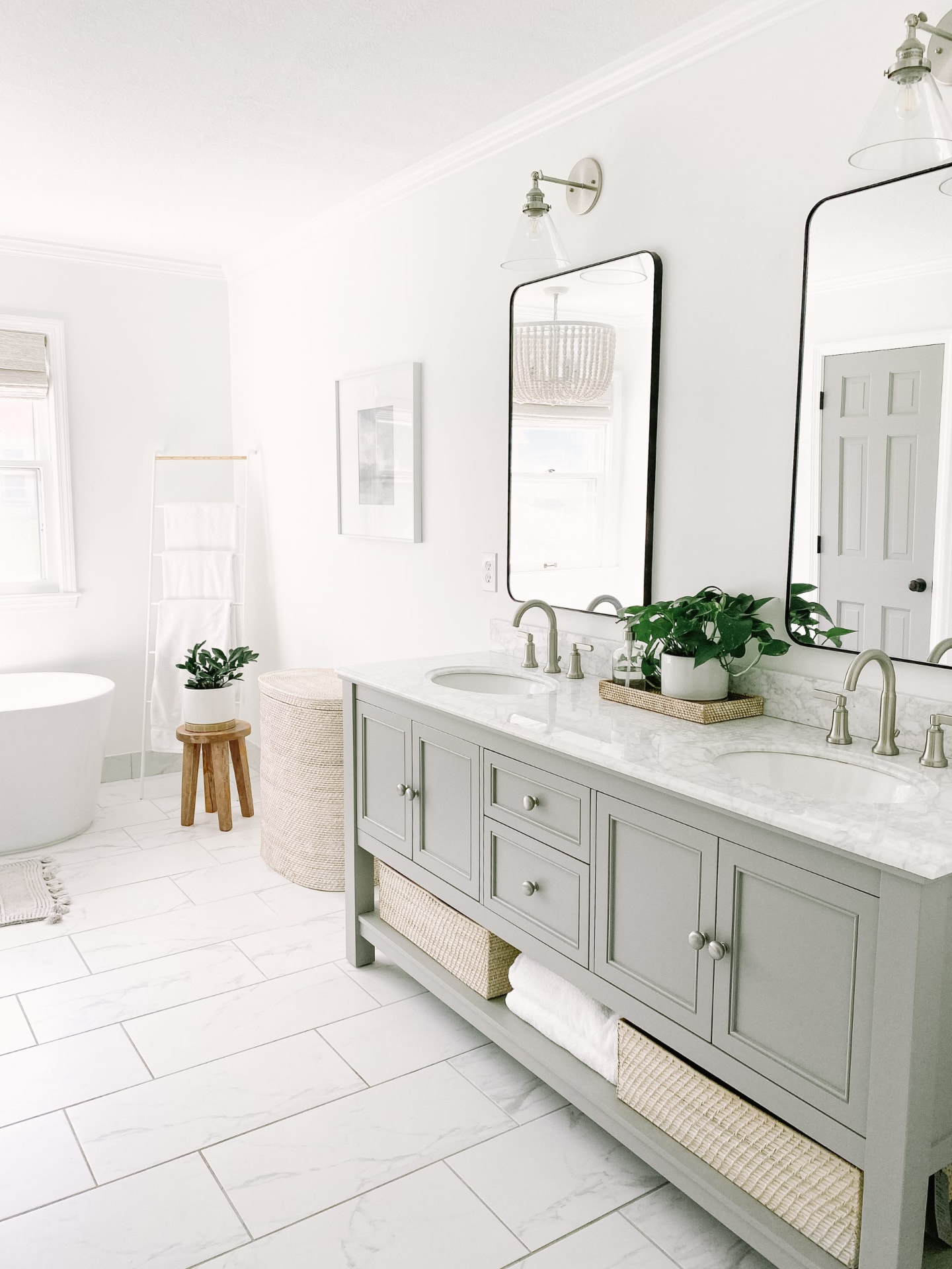 Bright custom bathroom renovation with grey double vanity and marble tile by GE Multi Service